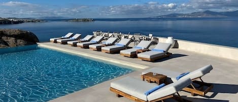 Seasonal outdoor pool, open 10:30 AM to 6:30 PM, pool umbrellas