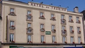 A building with the sign "HOTEL DU TOURING" indicating it is a hotel. - Hotel Du Touring (Saint-Cere)