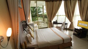 A hotel room with a bed, a desk, a chair, a TV, and a view of the outdoors. - Hotel Dolce Vita Resort (Bujumbura)
