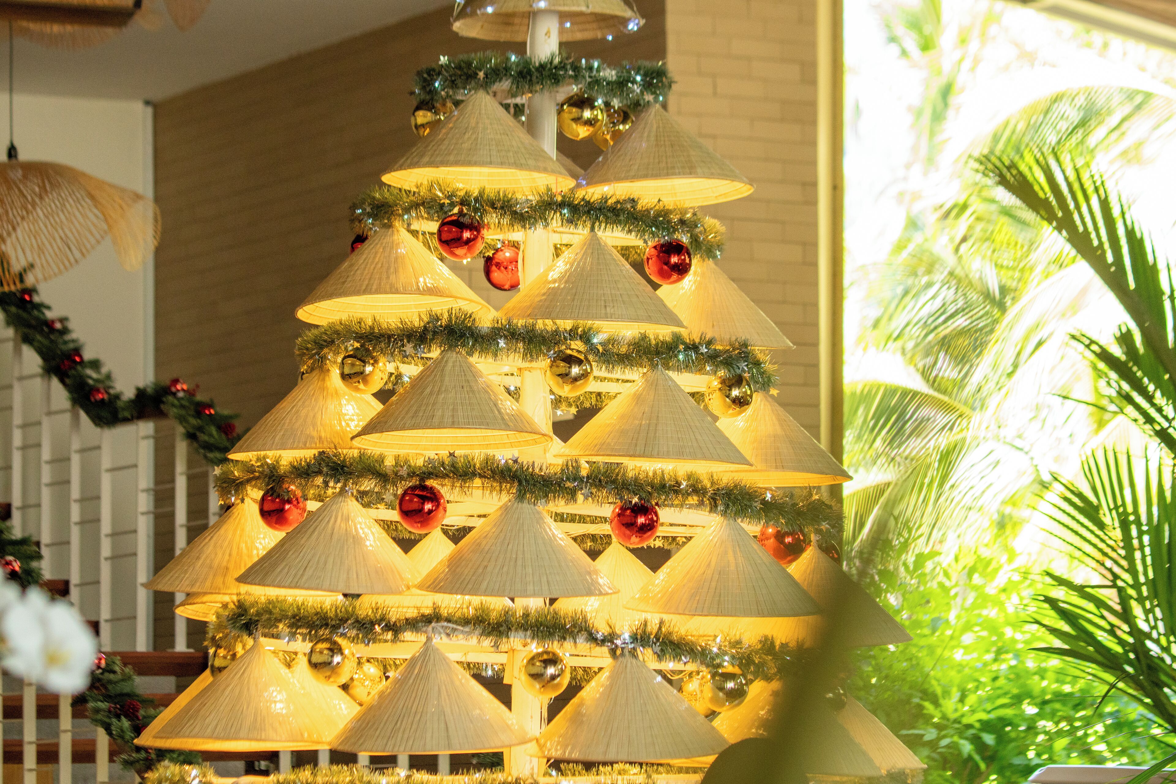 A multi-tiered Christmas tree with lights and ornaments.