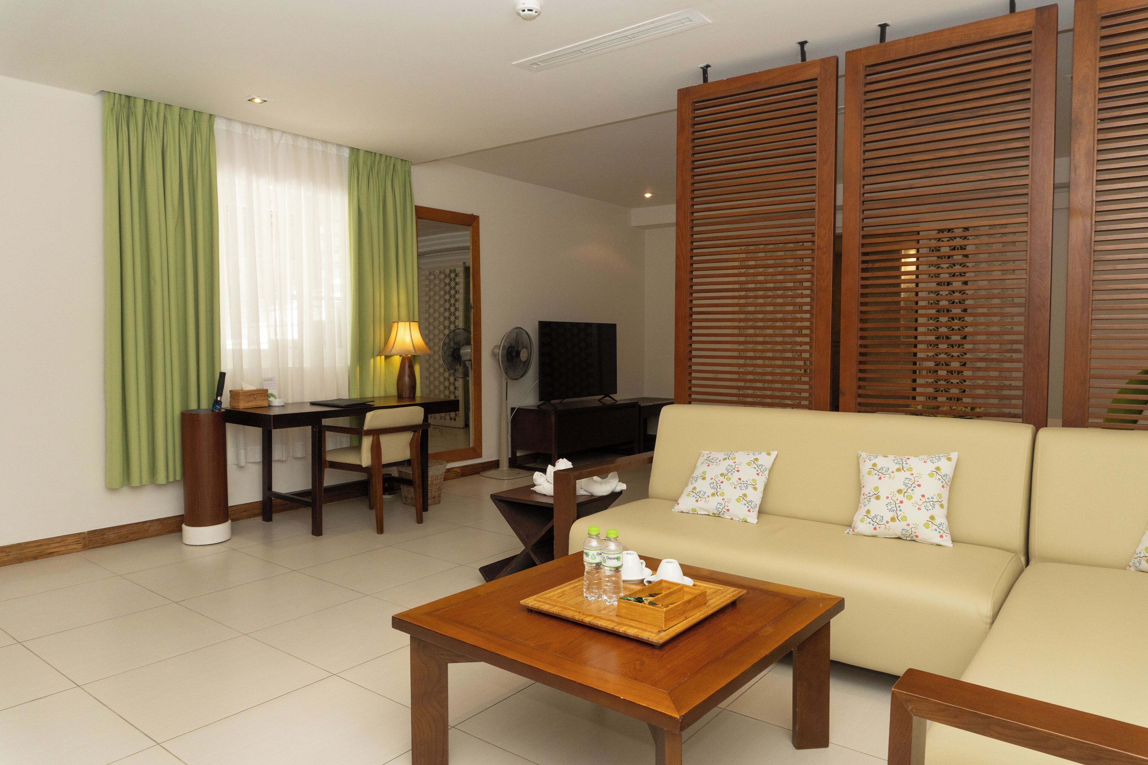 A modern living room with a sofa, coffee table, and a television.
