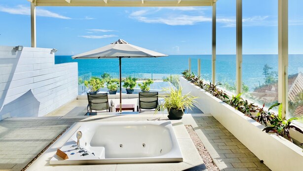 A rooftop terrace with a hot tub, seating area, and potted plants. - The Cliff Resort & Residences (Phu Thuy)