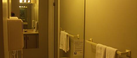 A bathroom with a sink, mirror, and towel rack.