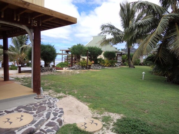 A covered outdoor area with a stone pathway leading to a building. - Tropical Sands (Rarotonga)
