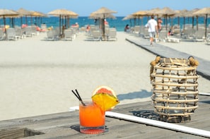 Enjoy a refreshing drink on the beach with a clear ocean view.