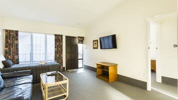 Executive One Bedroom | Living room | 40-inch flat-screen TV with digital channels, TV, Netflix
