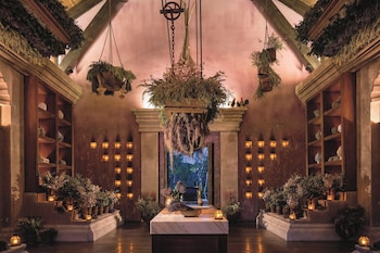 A spacious living area with a television, seating, and a view of the ocean. at Dorado Beach, a Ritz-Carlton Reserve