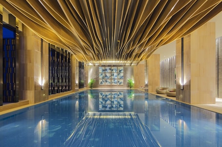Indoor pool, sun loungers. Crowne Plaza Tianjin Meijiangnan by IHG