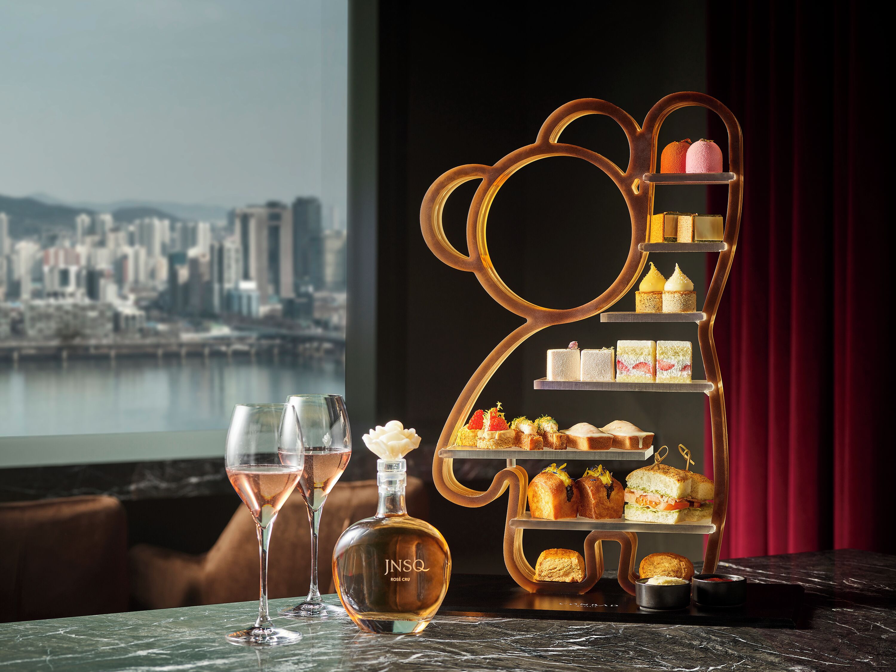 A dessert display with a city view in the background.
