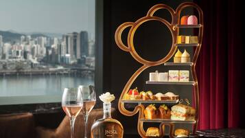 A dessert display with a city view in the background.