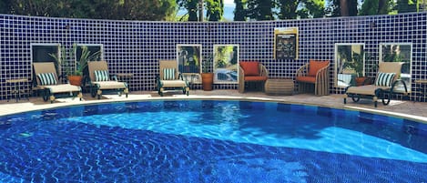 Outdoor pool, open 7:00 AM to 10:00 PM, pool umbrellas, pool loungers