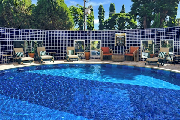 Outdoor pool, open 7:00 AM to 10:00 PM, pool umbrellas, pool loungers