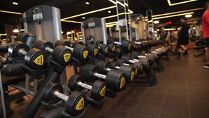 A gym with rows of dumbbells and weight machines. - Alameda Vitória Hotel (Vitoria)