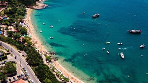 On the beach, white sand, sun-loungers, beach umbrellas