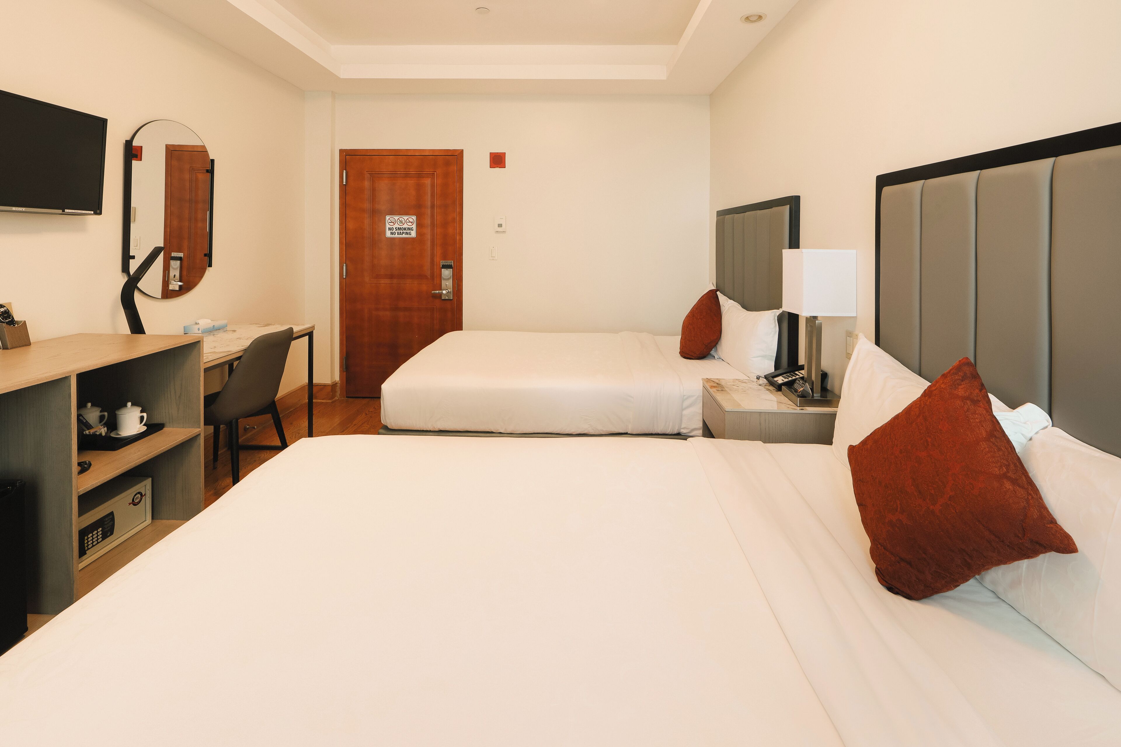 deluxe double room, 2 double beds | in-room safe, desk, laptop workspace, iron/ironing board