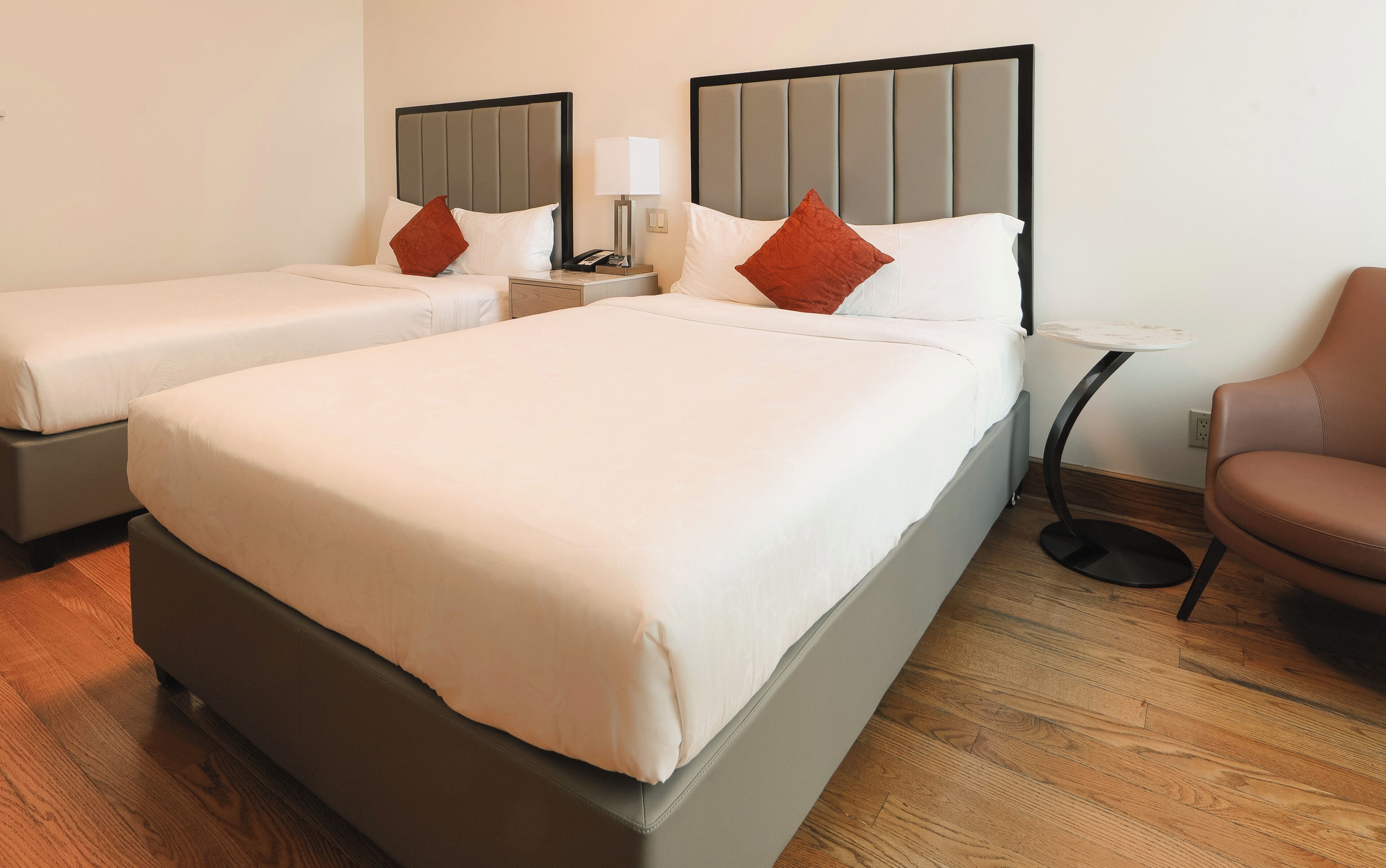 deluxe double room, 2 double beds | in-room safe, desk, laptop workspace, iron/ironing board
