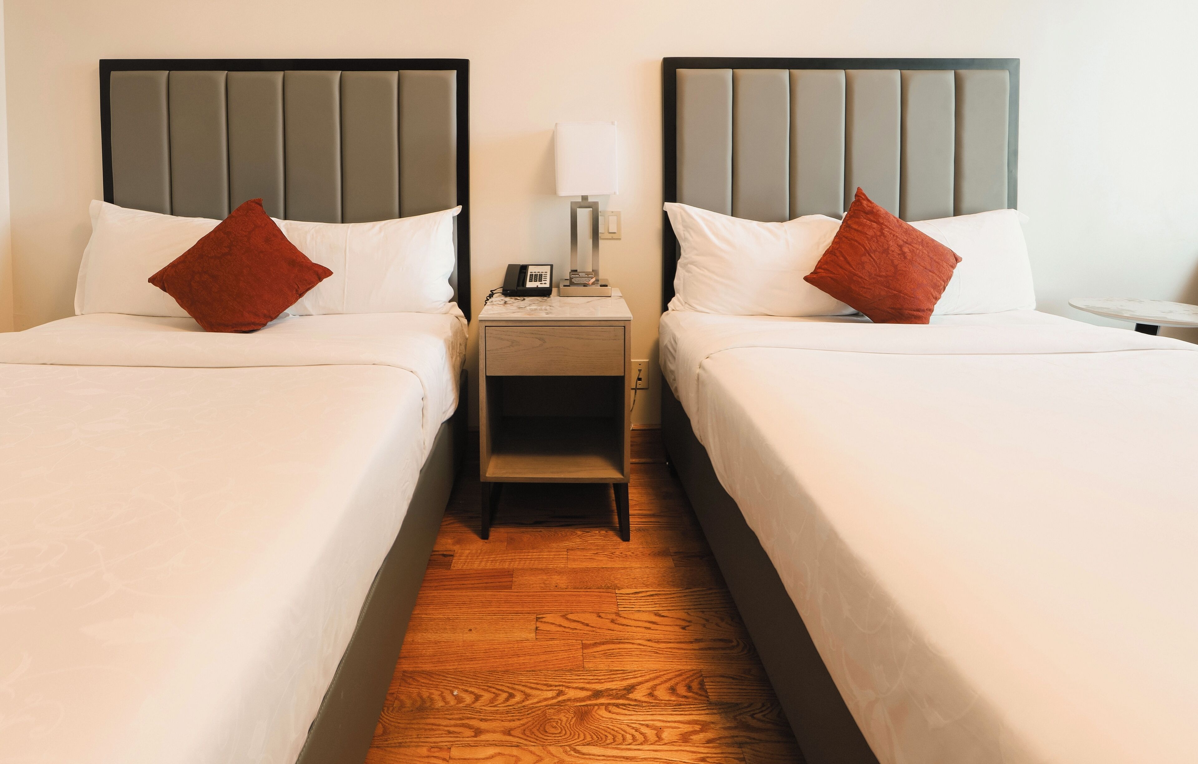 deluxe double room, 2 double beds | in-room safe, desk, laptop workspace, iron/ironing board