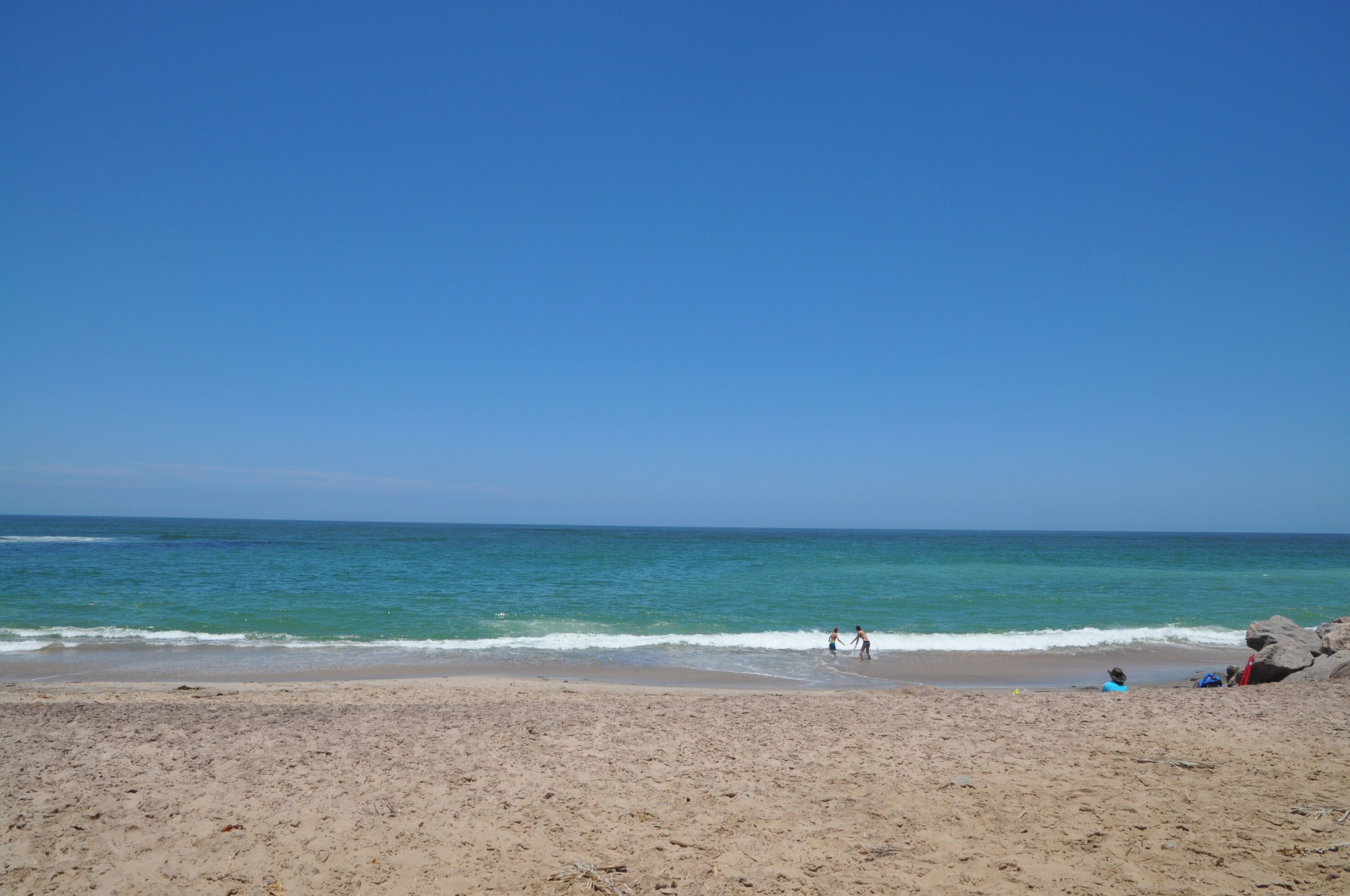 A beach with clear skies and calm waters.