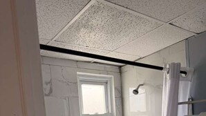 A bathroom with a shower, a window, and a toilet. - Hammock Inn & Suites - Jersey Shore (Seaside Heights)