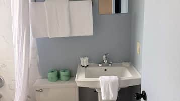 Premium bedding, desk, laptop workspace, blackout drapes