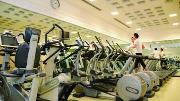 A gym with multiple treadmills and exercise machines.