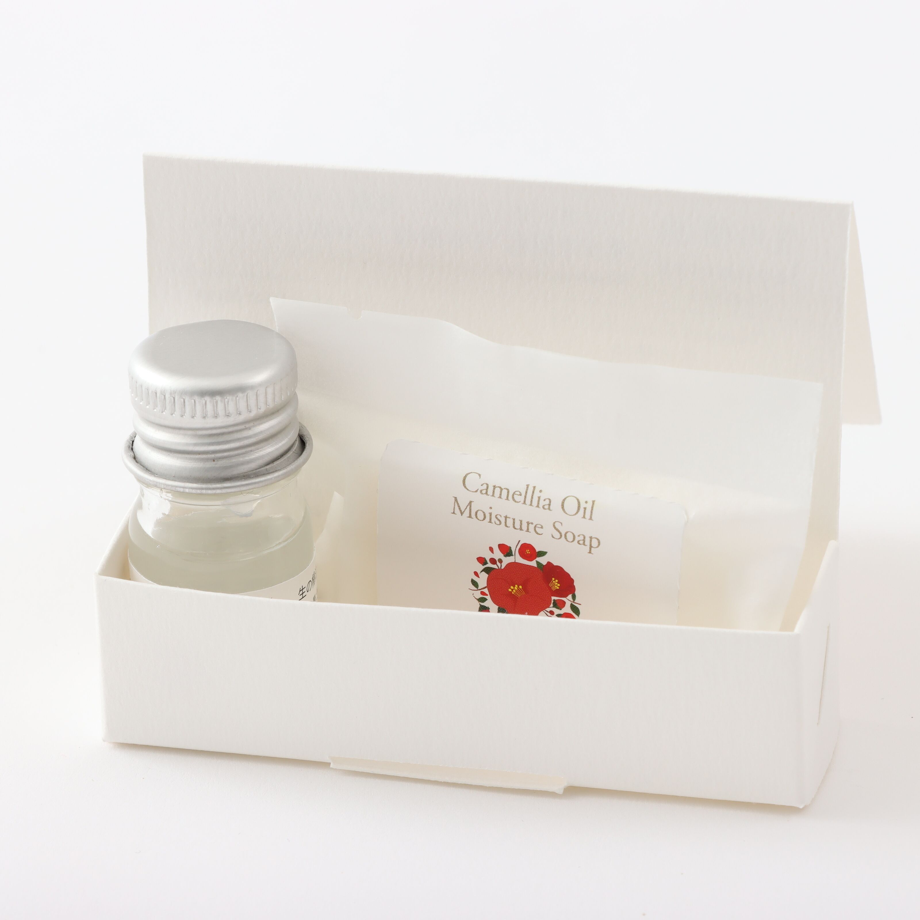 Eine weiße Schachtel mit Kamellia Öl Feuchtigkeitsseife und ihrer Verpackung.