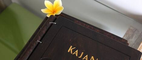 A dark wooden box with the word "KAJANE" embossed on it.