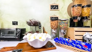 A buffet setup with various food items, including hard-boiled eggs, cereal, and pastries. - Hollywood Beach Blue Wave (Hollywood)