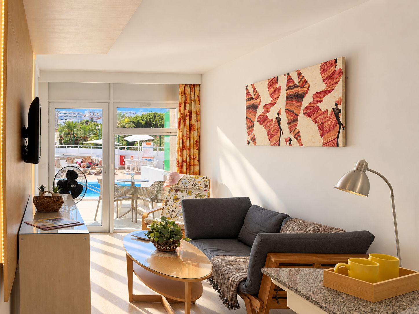 A modern living room with a sofa, a coffee table, a TV, and a painting.