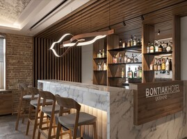 A bar area with a marble countertop, wooden chairs, and a wooden slatted wall.