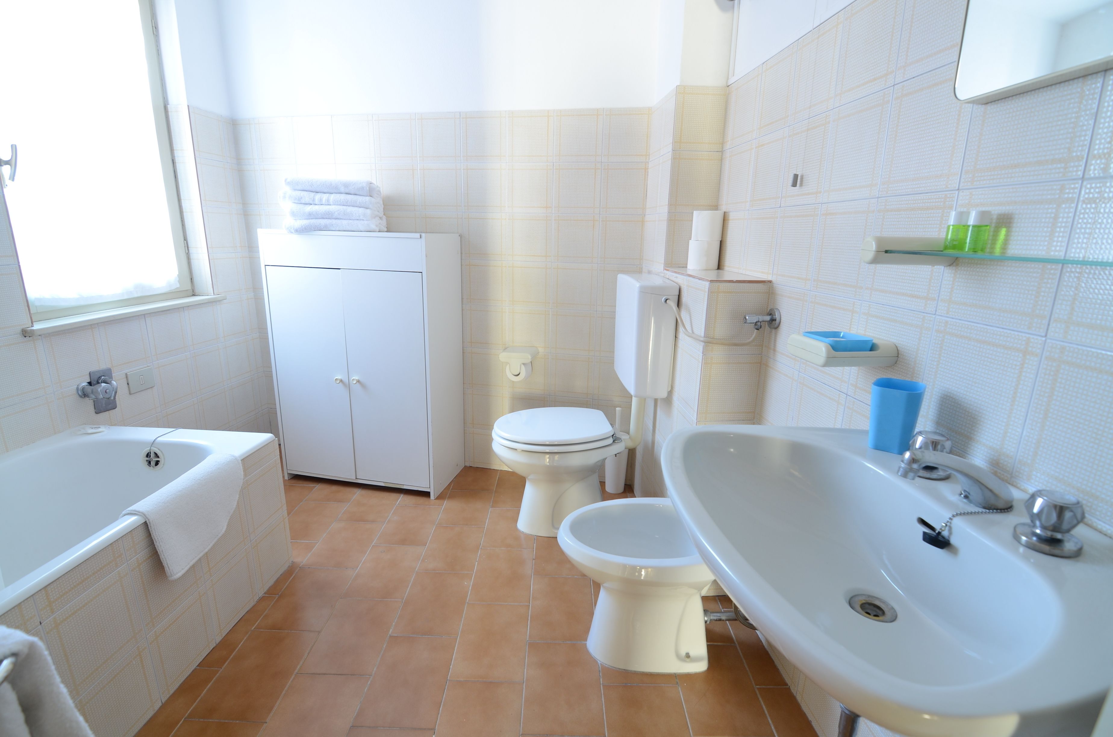 A bathroom with a bathtub, toilet, and sink.