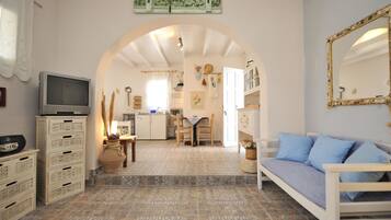 Deluxe Quadruple Room | Living room | Flat-screen TV