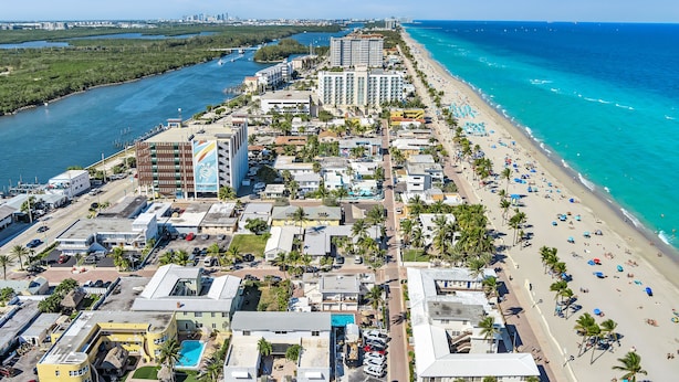 An aerial view of a coastal city with a beach, buildings, and a marina. - Hollywood Beach Flamingo (Hollywood)
