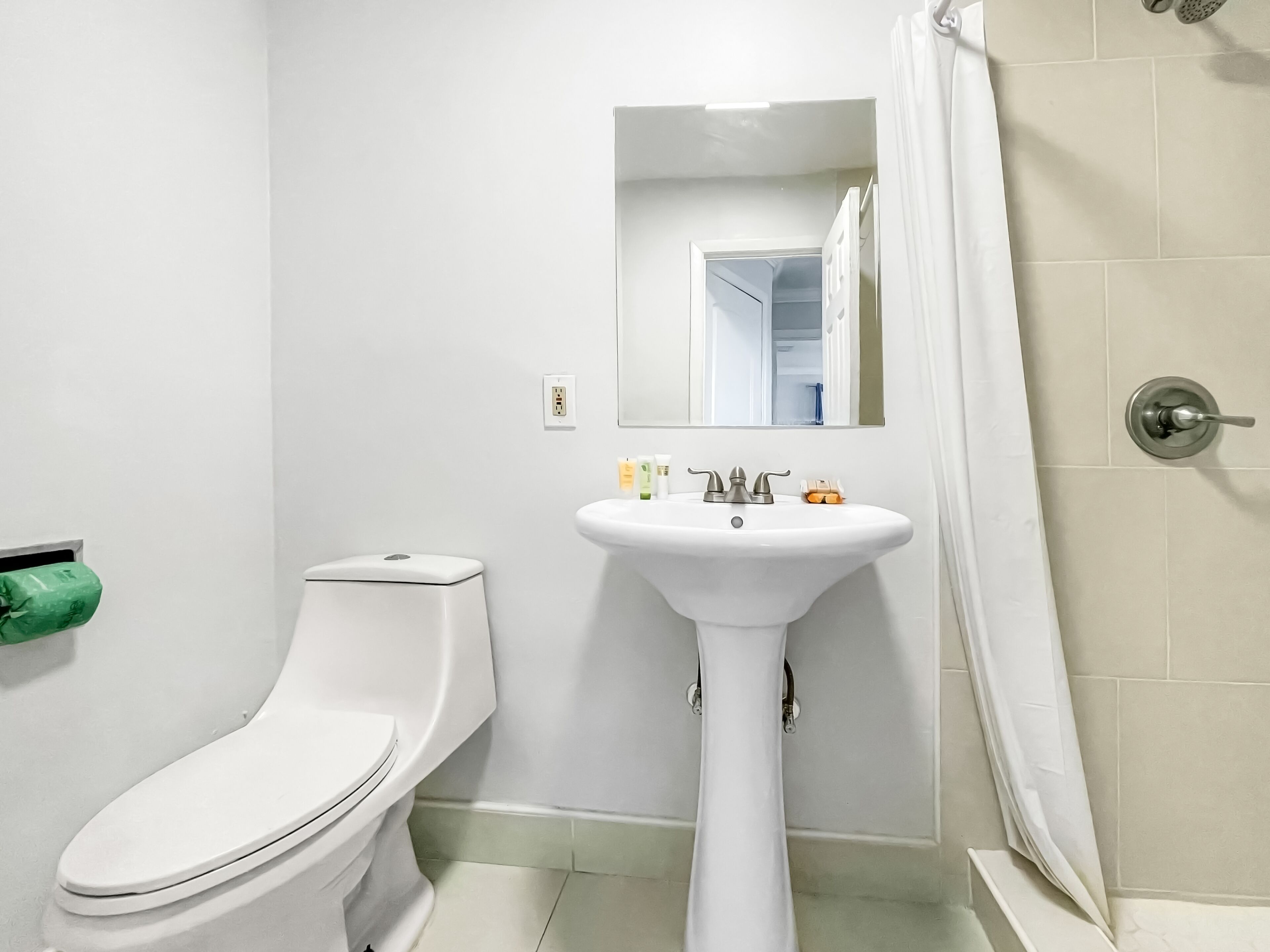 Un baño con inodoro, lavamanos y ducha.