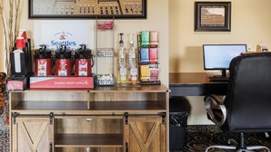 A hotel reception area with a coffee station, a computer, and a framed picture of a building.