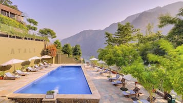 Outdoor pool, open 8:00 AM to 8:00 PM, pool umbrellas