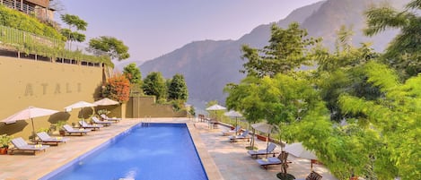 Outdoor pool, open 8:00 AM to 8:00 PM, pool umbrellas