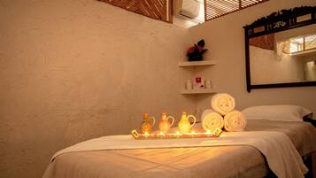 Relax in a cozy space with a comfortable bed, a wall-mounted shelf, and a mirror.