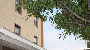 A hotel with a covered porch, brick facade, and a sign for Key West Hotel.