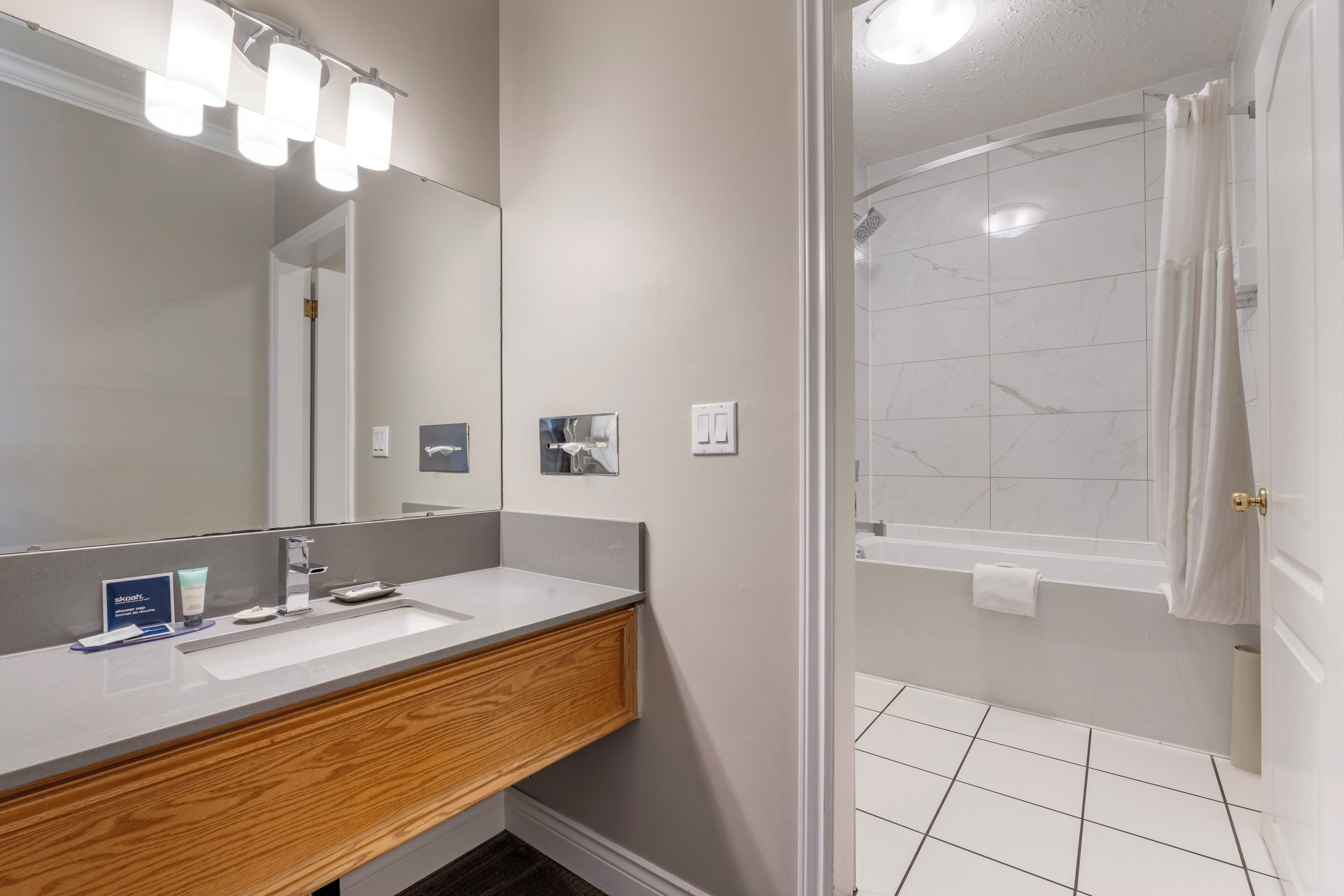 deluxe room, 2 queen beds | bathroom | designer toiletries, hair dryer, towels, soap