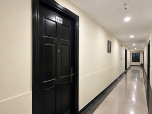 A corridor with a black door marked with the number 616, leading to a room. - Victorian Nha Trang Hotel (Nha Trang)