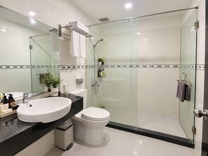 A modern bathroom with a glass-enclosed shower, a white sink, and a toilet. - Victorian Nha Trang Hotel (Nha Trang)