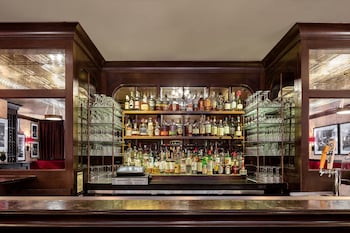 A detailed architectural arch with intricate carvings and an eagle sculpture. at Walker Hotel Greenwich Village