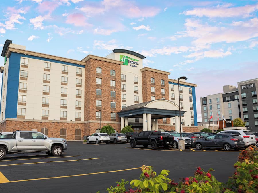 A Holiday Inn Express & Suites hotel with a parking lot in front.