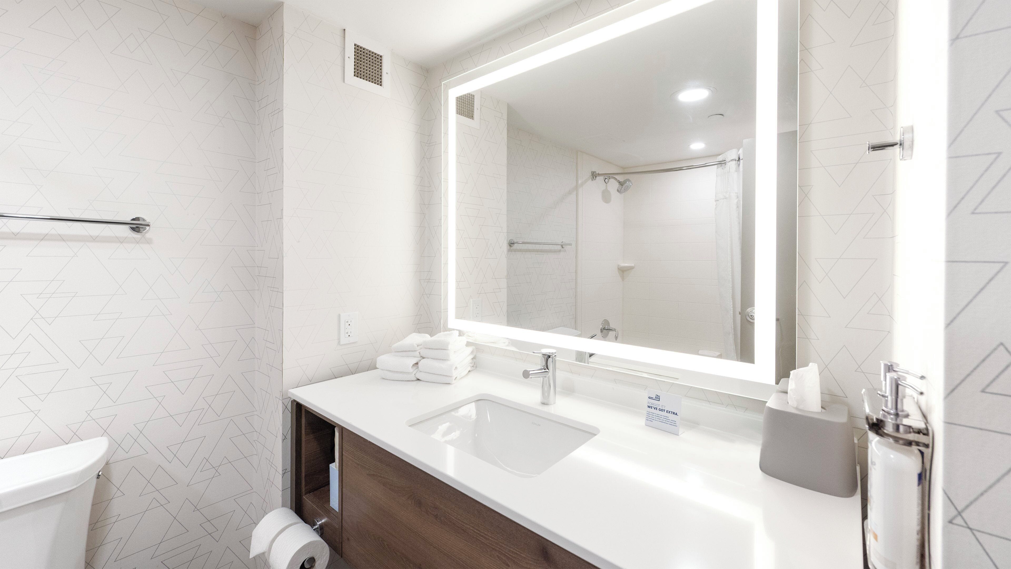 designer toiletries, hair dryer, towels, soap