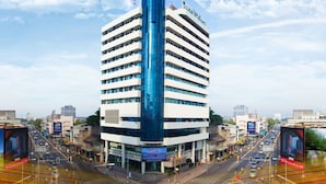 A modern hotel with a distinctive blue and white facade, multiple floors, and a prominent entrance. - V.L. HatYai Hotel (Hat Yai)