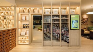 A modern retail store with wooden shelving and a central display area. - V.L. HatYai Hotel (Hat Yai)