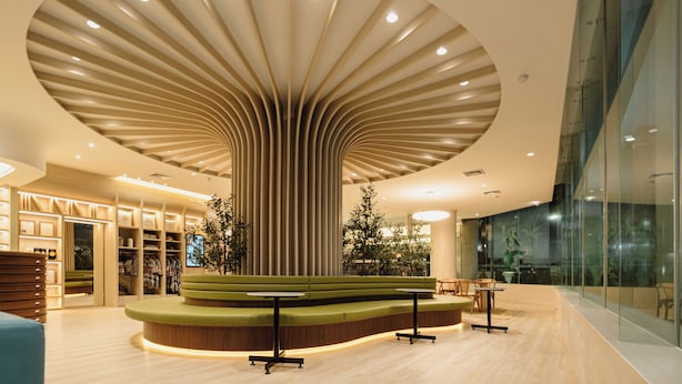 A modern interior with a central seating area, a curved ceiling design, and a glass wall on one side. - V.L. HatYai Hotel (Hat Yai)