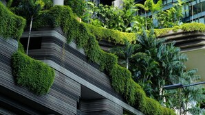 A modern building with multiple levels of greenery and architectural features.