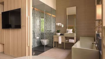 A modern bathroom with a glass-enclosed shower, a freestanding bathtub, and a vanity with a mirror.